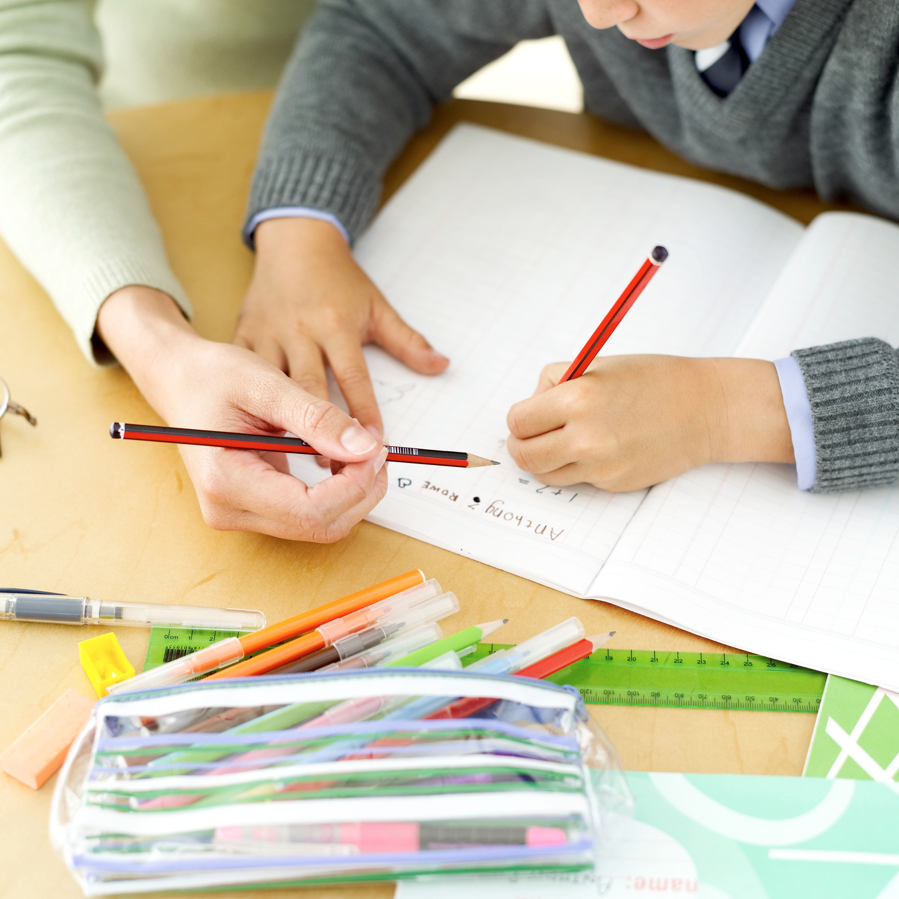 young boy being tutored by his teacher